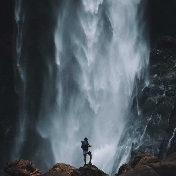 Standing before the magnificent view of a waterfall. Seeing enormous amount of w...