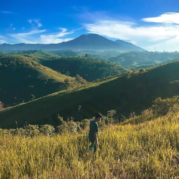 Stepping on the grass, surrounded by mountains. What a fine morning view! Taken ...