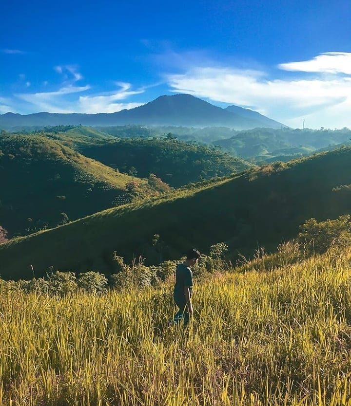 Stepping on the grass, surrounded by mountains. What a fine morning view! Taken ...
