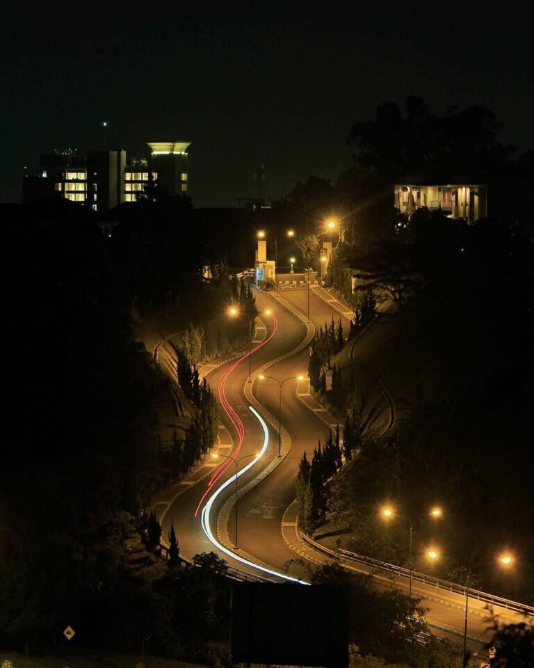 Riding slow in the tranquility in darkness, way up streaking red schemes of the ...