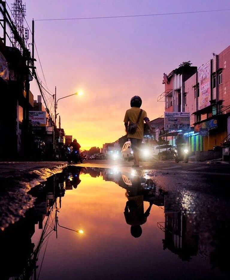 The purple sky, the sunset, and the reflection from the puddle beautifully taken...