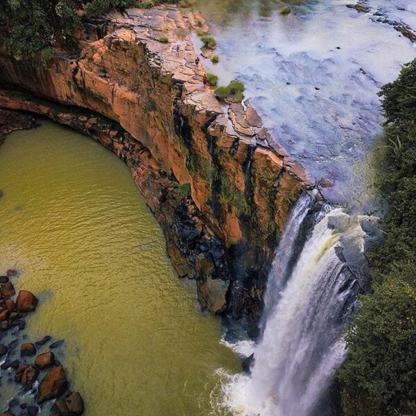 Can you see tiny people walking around the waterfall?
-
Aerial shot of Curug Awa...