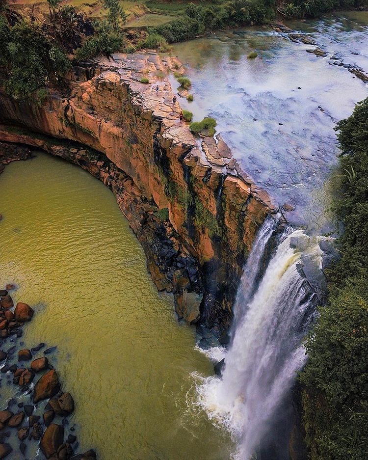 Can you see tiny people walking around the waterfall?
-
Aerial shot of Curug Awa...
